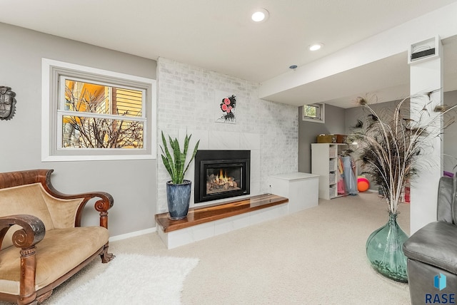 carpeted living room featuring recessed lighting, baseboards, and a large fireplace