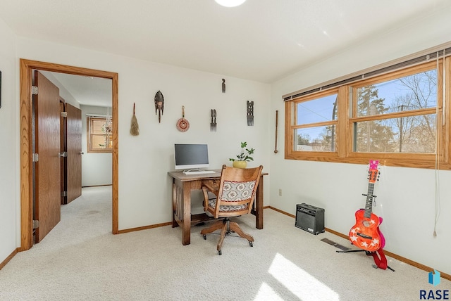 carpeted home office with visible vents, baseboards, and a wealth of natural light