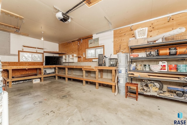 garage with a workshop area and a garage door opener