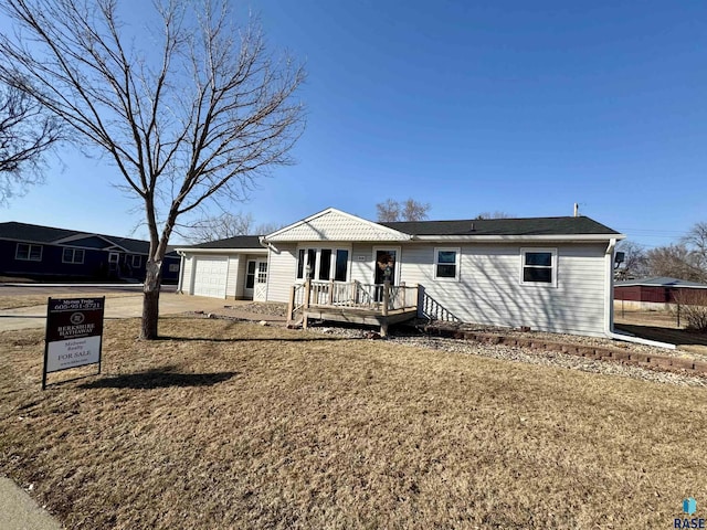 back of house with a deck and a garage