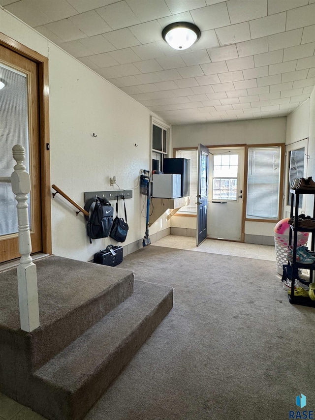 interior space with carpet flooring and baseboards