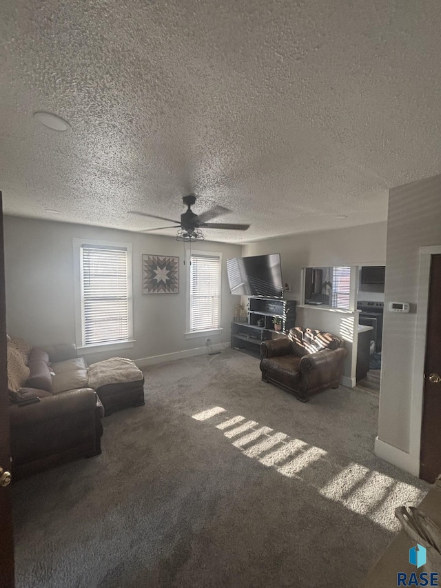 living room featuring baseboards, a ceiling fan, and carpet floors