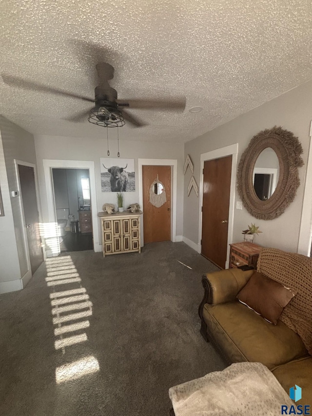 carpeted living room with baseboards, a textured ceiling, and ceiling fan