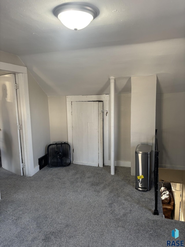 bonus room featuring carpet floors and vaulted ceiling