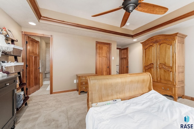 bedroom featuring recessed lighting, light colored carpet, baseboards, and a tray ceiling