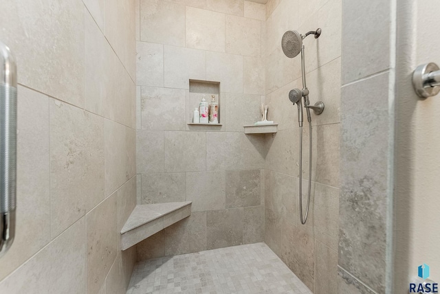 full bath with a tile shower