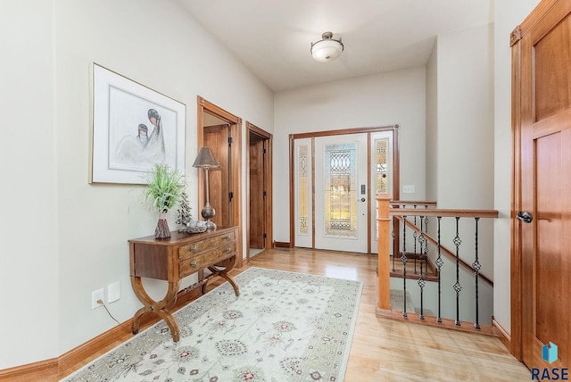 foyer entrance with light wood-type flooring and baseboards