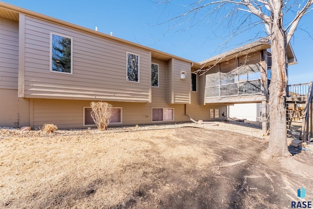 back of house featuring a sunroom