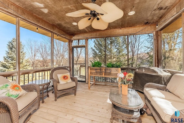 sunroom featuring a wealth of natural light and ceiling fan