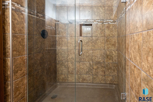 full bath featuring a shower stall