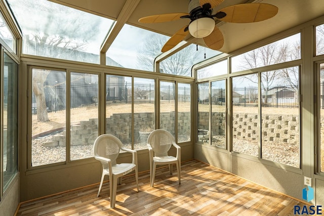 sunroom with a wealth of natural light and ceiling fan