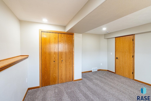 unfurnished bedroom featuring visible vents, baseboards, and carpet floors