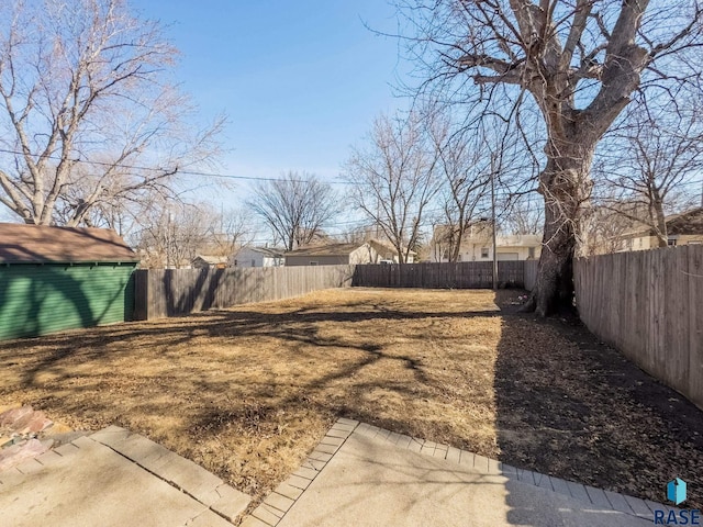 view of yard with an outdoor structure and a fenced backyard