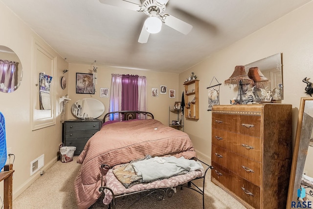 bedroom with visible vents, light carpet, baseboards, and a ceiling fan