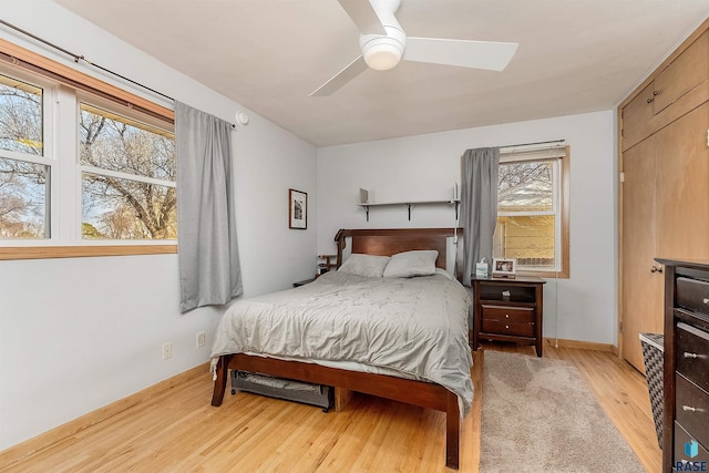 bedroom with light wood-type flooring and ceiling fan