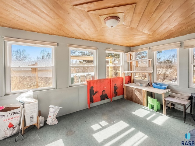 sunroom / solarium featuring lofted ceiling and wooden ceiling