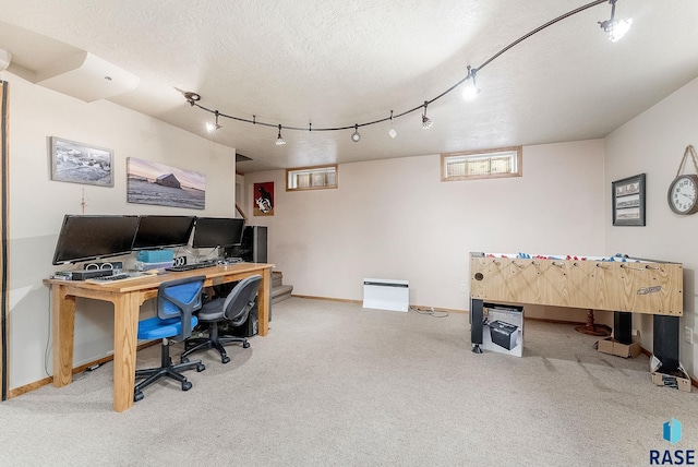 office space with rail lighting, carpet, baseboards, and a textured ceiling