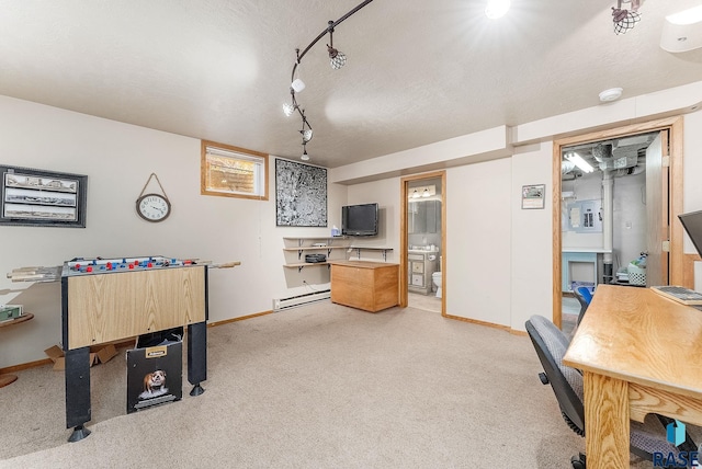 interior space featuring light carpet, track lighting, a textured ceiling, a baseboard radiator, and baseboards