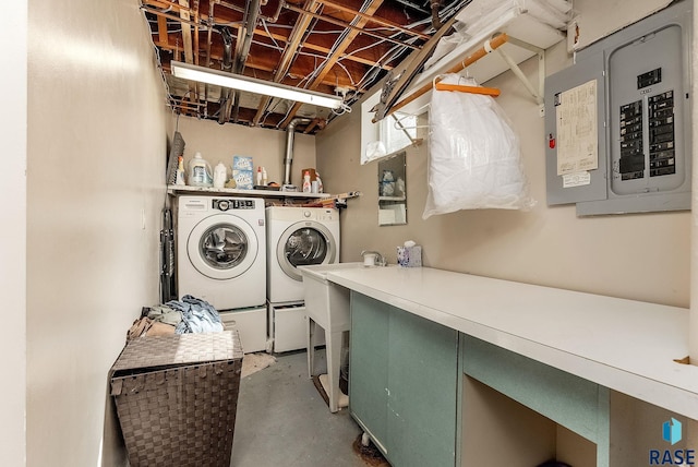 clothes washing area featuring electric panel, laundry area, and separate washer and dryer