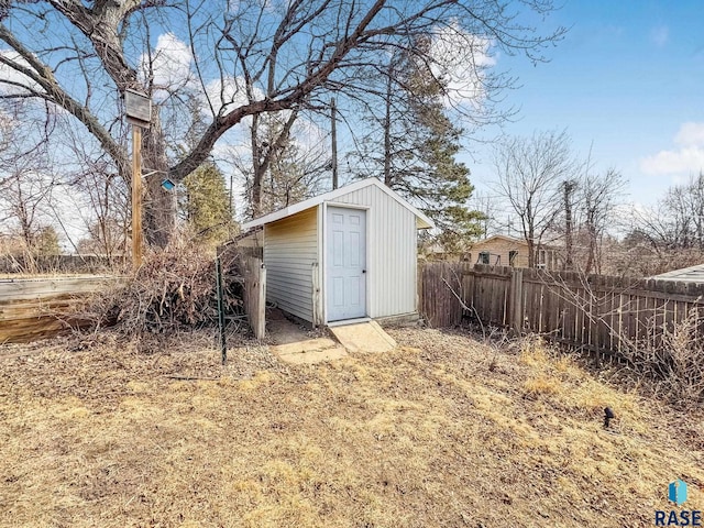 view of shed featuring fence