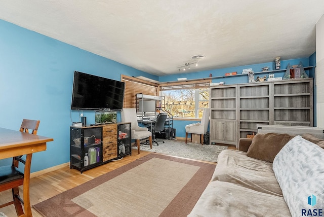 living room with baseboards and wood finished floors