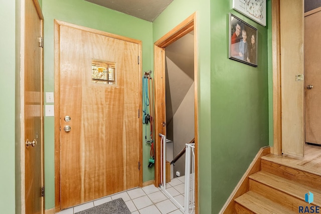 doorway to outside with tile patterned floors