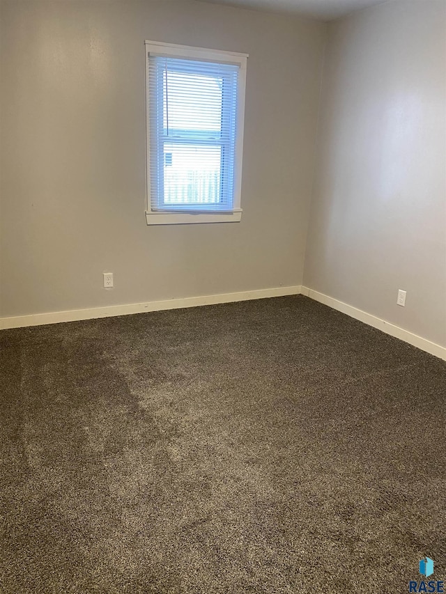 carpeted empty room with baseboards