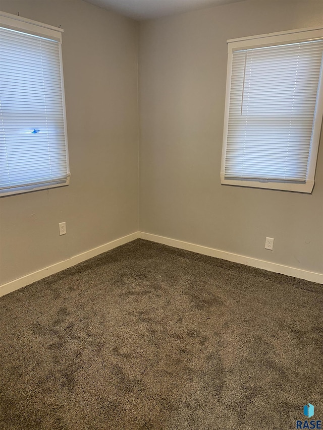 empty room with baseboards and carpet floors