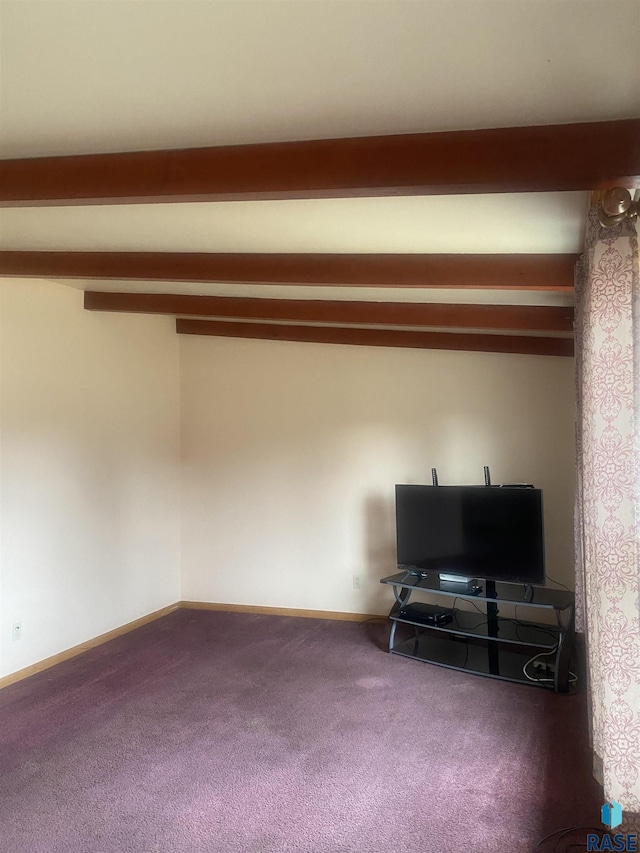 interior space with beam ceiling and baseboards