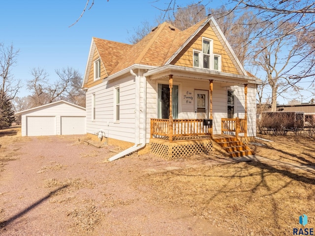 view of front of home with a detached garage, a porch, fence, an outdoor structure, and a shingled roof