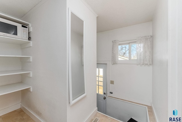 interior space with tile patterned floors and baseboards