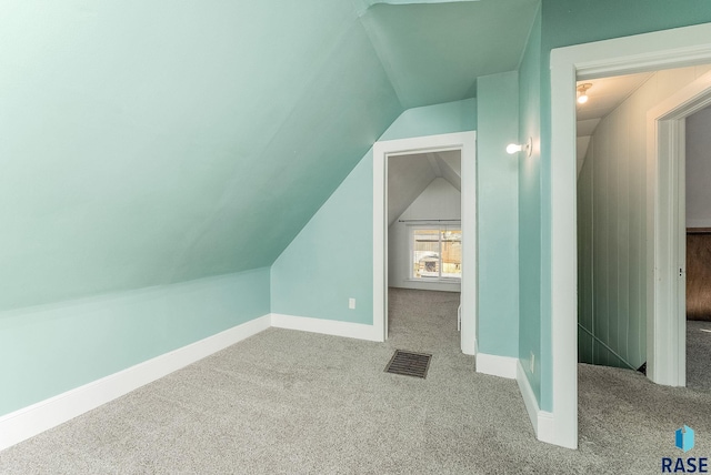 bonus room featuring visible vents, carpet flooring, baseboards, and vaulted ceiling