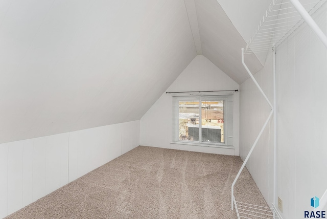 bonus room featuring lofted ceiling and carpet floors