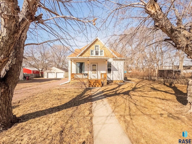 bungalow-style house with a porch and an outdoor structure