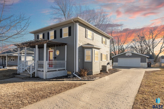 american foursquare style home featuring central AC, a garage, covered porch, and an outdoor structure