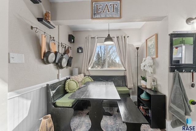 dining room with a wainscoted wall