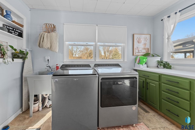 washroom featuring cabinet space and separate washer and dryer