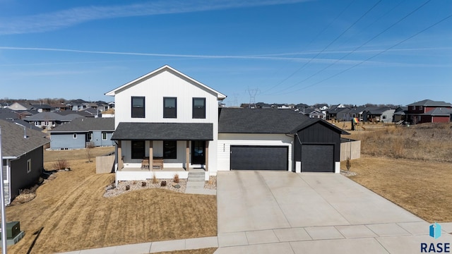 modern inspired farmhouse with a residential view, covered porch, concrete driveway, a shingled roof, and a garage