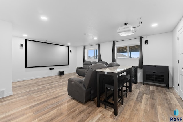 cinema featuring visible vents, recessed lighting, light wood-style floors, and baseboards