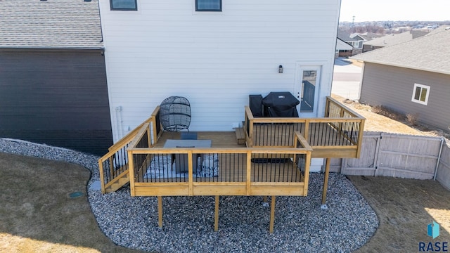 rear view of property with a deck and fence