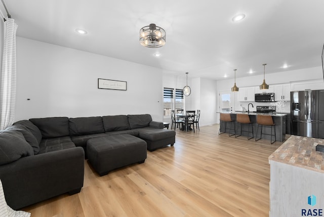 living room with recessed lighting and light wood finished floors