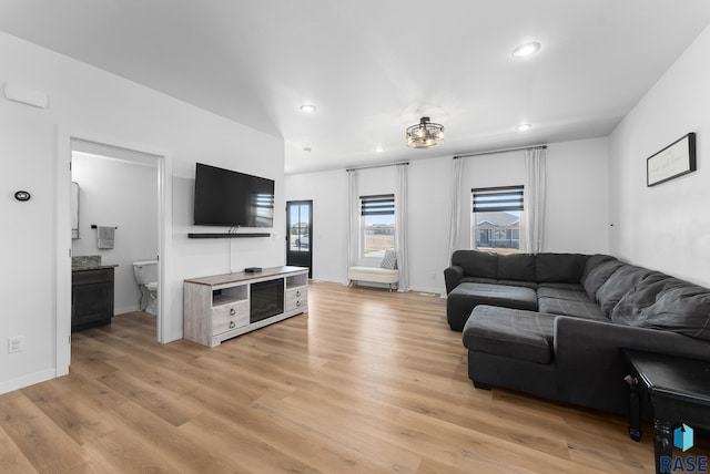 living room with recessed lighting, light wood-style floors, and baseboards