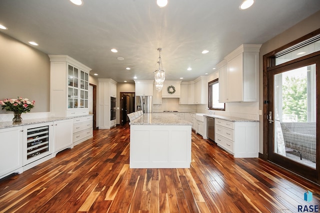 kitchen with stainless steel appliances, wine cooler, white cabinets, and dark wood-style flooring