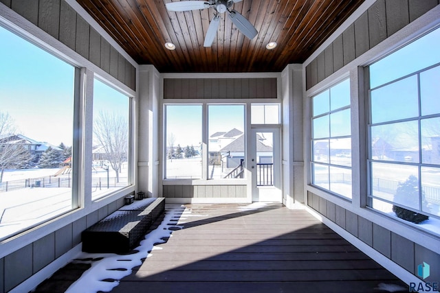 unfurnished sunroom featuring wooden ceiling and ceiling fan