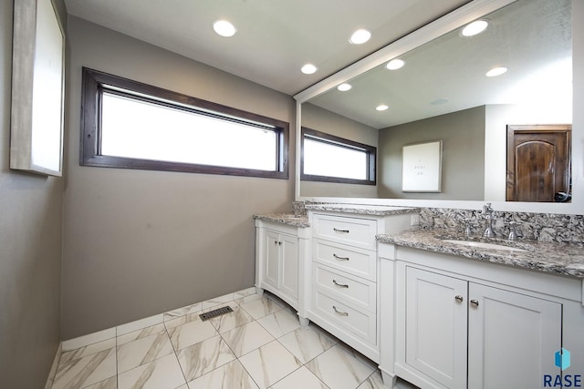 full bath featuring visible vents, marble finish floor, a sink, recessed lighting, and double vanity