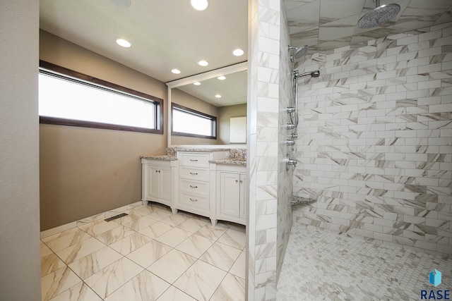 full bathroom with visible vents, recessed lighting, tiled shower, and vanity