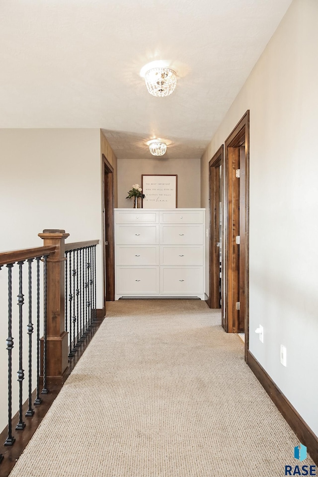 corridor featuring carpet flooring and baseboards