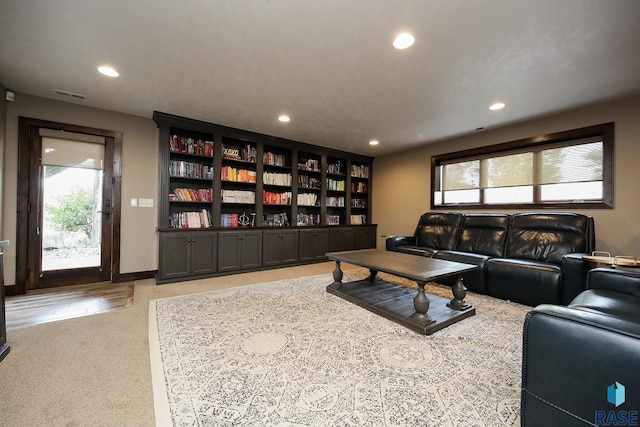 living room with recessed lighting, visible vents, carpet floors, and baseboards