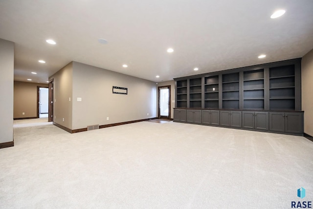 empty room featuring recessed lighting, baseboards, and light carpet