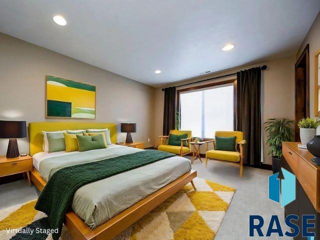 bedroom with light carpet, visible vents, and recessed lighting